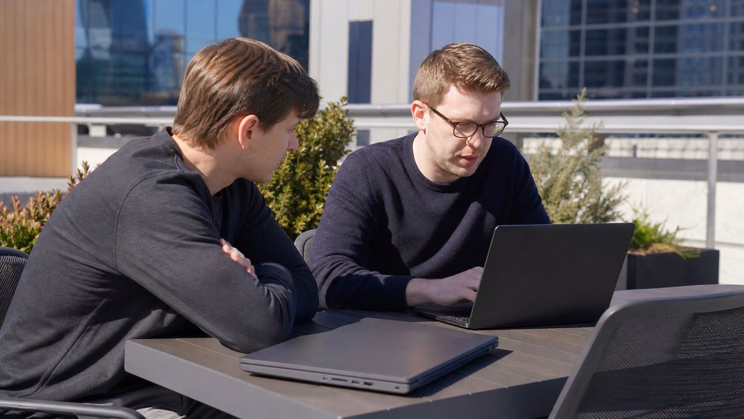 OUTDOOR TERRACE An IT professional one or two people working at a table on a