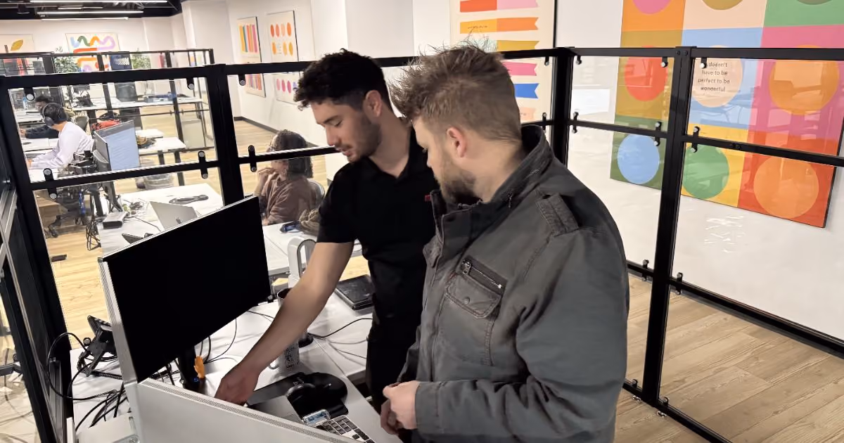 Two MBPS engineers reviewing IT compliance evidence on a monitor